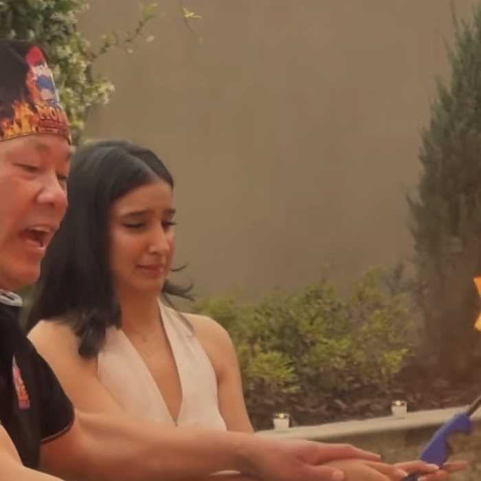 Hibachi chef and a guest reacting to the fire show